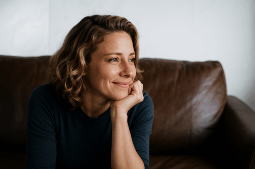 Une femme souriante après une session de réflexion transformante