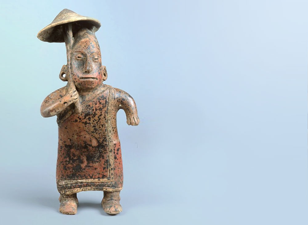 An old Aztec figure with a magic mushroom